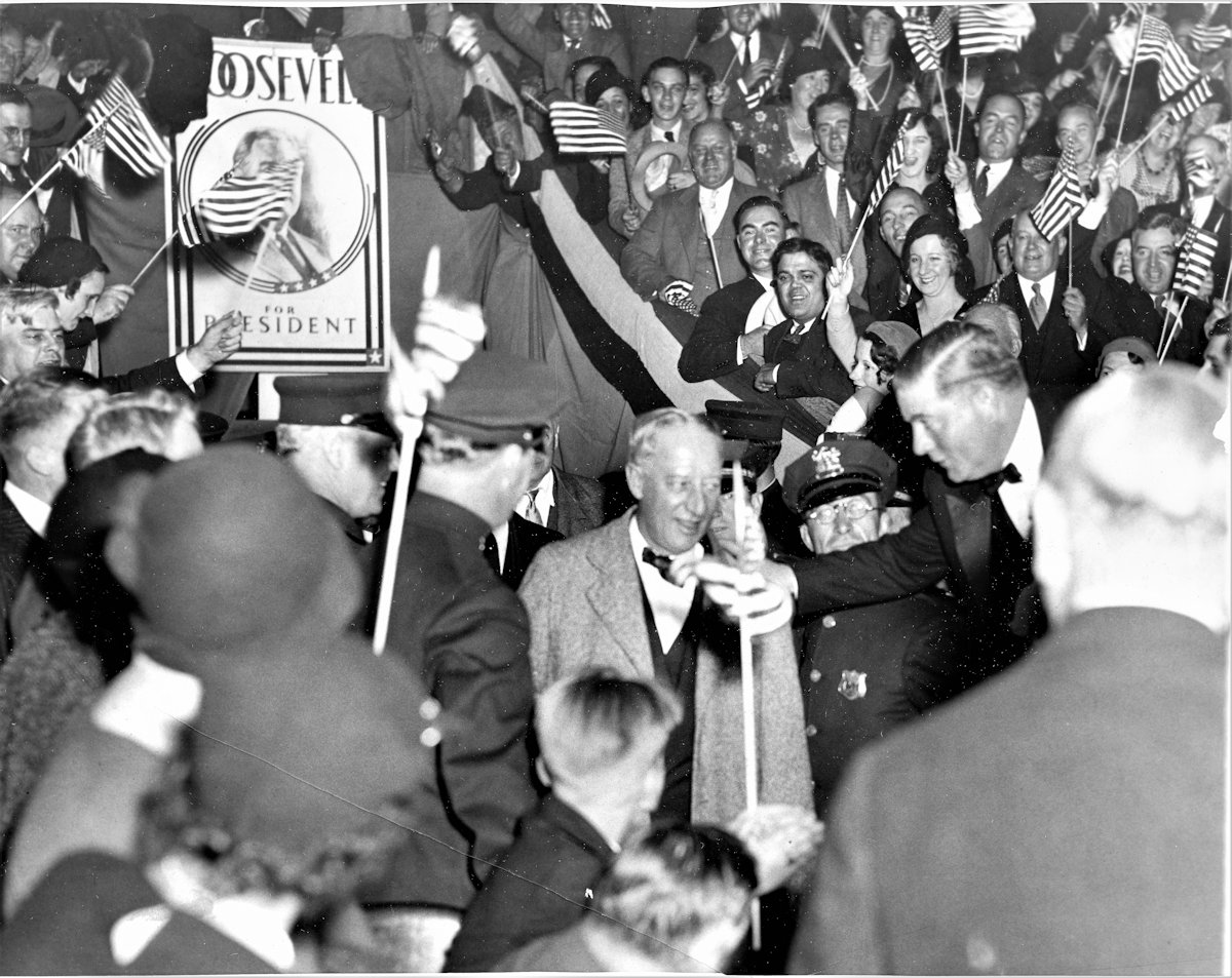 Al Smith
With the crowd that filled the Newark, N. J. Armory wildly cheering and waving their flags, former Governor Alfred E. Smith of New York slowly worked his way to the platform where he made his first campaign talk in behalf of the Roosevelt/Garner ticket.  Here he is making an impromptu talk before a microphone that was hastily thrust in front of him before he ascended the platform 10/24/1932

Photo from Joseph Bilby
