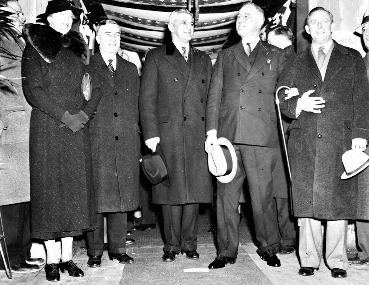 Ellenstein, Meyer
Approximately 400 federal officials engaged in directing emergency activities in New Jersey, gave President Roosevelt a rousing welcome when he stopped off in Newark en route to New York to attend their semi-annual meeting at the Robert Treat Hotel.  Left to right, Mrs. Franklin D. Roosevelt, Charles Edison (son of the late electrical wizard), State Director of the National Emergency Council, Mayor Ellenstein of Newark, President Roosevelt and Gus Gennerich, Secret Service Man.
January 18, 1936
Photo from Joseph Bilby
