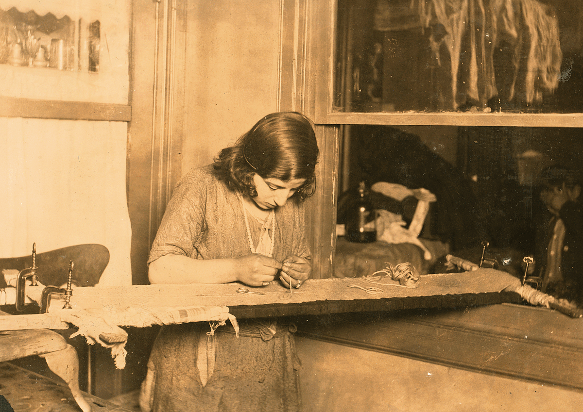 Before 1923, a girl of 13 working at embroidery in a far corner of a dimly lighted room. The light came from a small gas jet which was high above the girl's head, in the center of the room. She was working on a black dress which was outlined in black pencil. For this dress elaborately embroidered, she received ninety cents. She could embroider one dress in about three or four days if she kept at it steadily. She had been working since 4 P.M., and it was the 7 P.M. She expected to stop at 10:30. Location: Newark, New Jersey.

From “Library of Congress”
