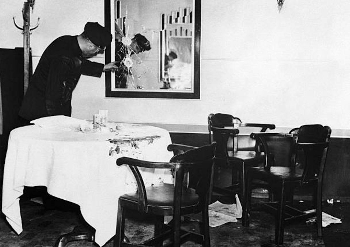 Assassination Scene
A Newark, New Jersey police officer examines a shattered mirror at the scene of the mob assassination of Arthur 'Dutch Schultz' Flegenheimer. Flegenheimer and three of his bodyguards, Otto Berman, Leo Frank, and Bernard Rosenkrantz, were fired upon by two unknown gunmen as they were dining at the steakhouse.
