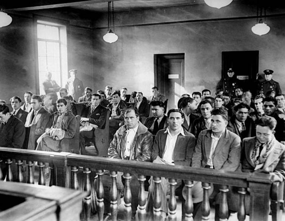 Illegal Aliens
Illegal aliens wait in Newark's Third Precinct station before being deported. 
Photo by NY Daily News
