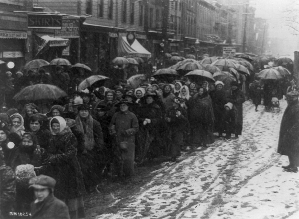 Newark Women
Women walking through snow and slush in Newark, New Jersey, to the city hall to place before Mayor Raymond a resolution calling for purchase and sale by the city of needed food.

Title: Newark women plod in snow to plea for food 
Date Created/Published: [ca. 1920]
Reproduction Number: LC-USZ62-96179 (b&w film copy neg.)
Rights Advisory: No known restrictions on publication.
Call Number: LOT 12354-1 <item> [P&P] 

