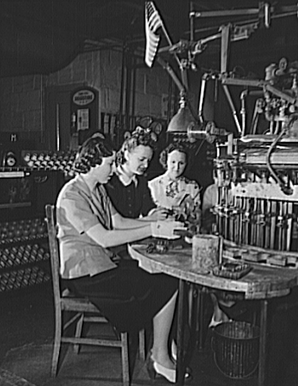 Petillo, Mary
Mary Petillo, forelady of a Newark, New Jersey factory making lamp bulbs and tubes for the Signal Corps, is an active member of her plant's laboratory management committee. The committee, set up in cooperation with the War Production Board's drive to speed victory, was elected in Mary's plant from a personnel of 1700, 350 of them men. Vice-president of her local, United Electrical, Radio and Machine Workers of America, Congress of Industrial Organization, Mary achieved the job of forelady by working working as a hand at many varied operations. She has made a suggestion to conserve bakelite lamp bases formerly discarded--a suggestion now in use at the plant--and is also the inventor of an apparatus which prevents short-circuiting during tests of lamps

From “Library of Congress”
