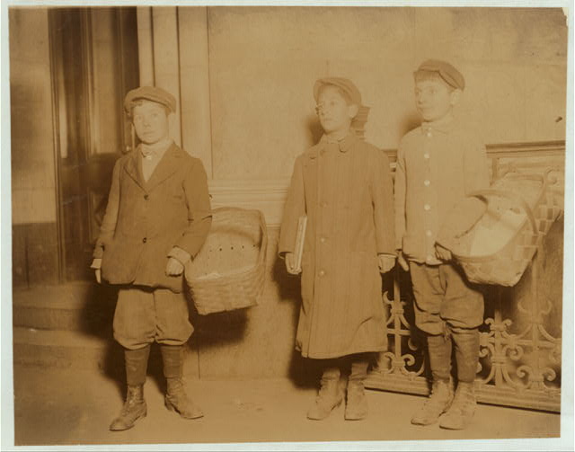 Pretzel and gum vendors - Newsies are good customers. A boy sells a basketful of pretzels every afternoon at the "news" office, to the boys getting their afternoon papers. Henry Schertzer, (left) 14 yrs. old. Abel Schertzer, (right) 12 yrs. old. Sam Tumin, (centre) 10 yrs. old. Sam sells gum, often till 10 P.M. Taken at 8:15 P.M. Location: Newark, New Jersey.

Library of Congress, Prints and Photograph Division, Washington, D.C. 20540 USA
